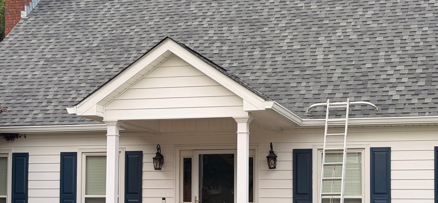 Finished Atlas shingle roof on a white house with a gabled porch
