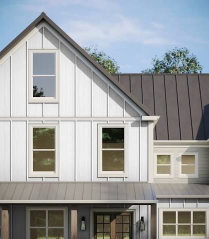 Board and batten gable meeting a standing-seam roof
